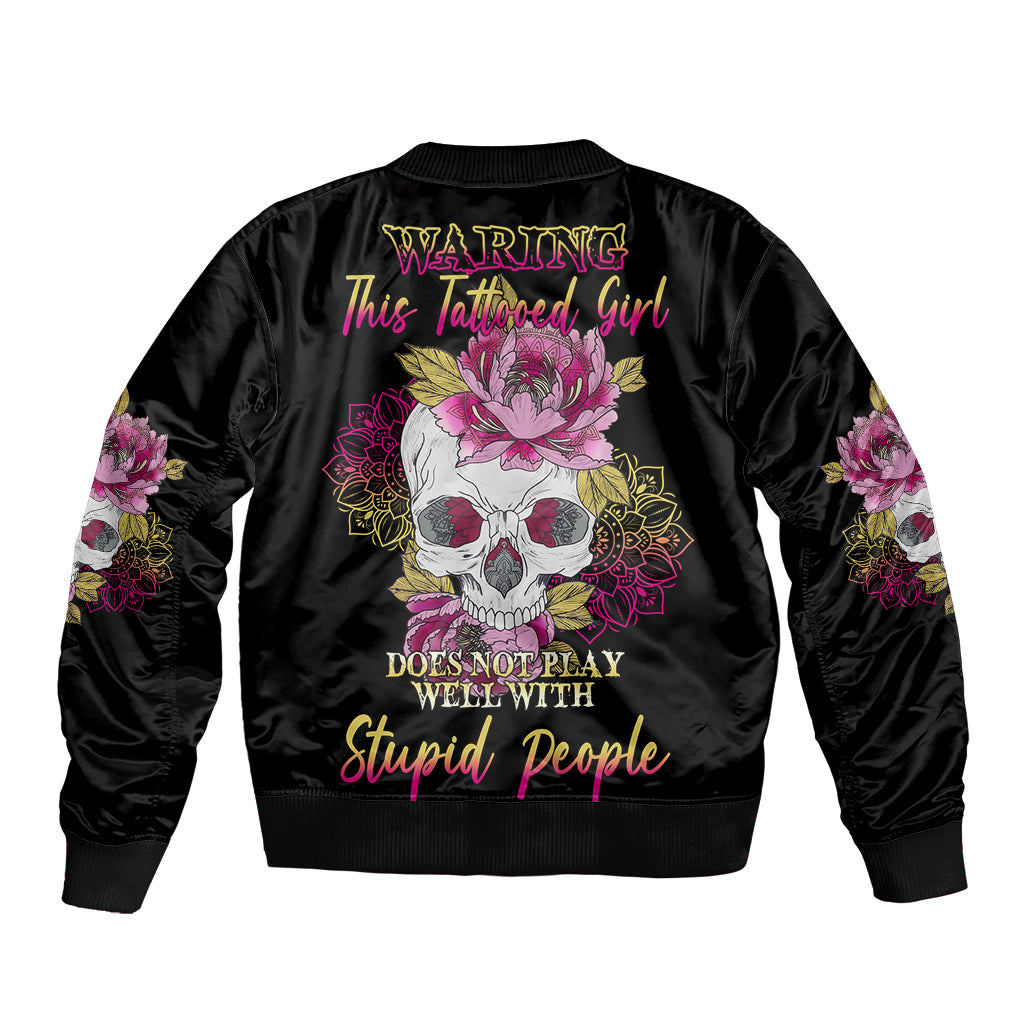 Black bomber jacket with ribbed collar, back skull-flower graphic, and sleeve floral patches