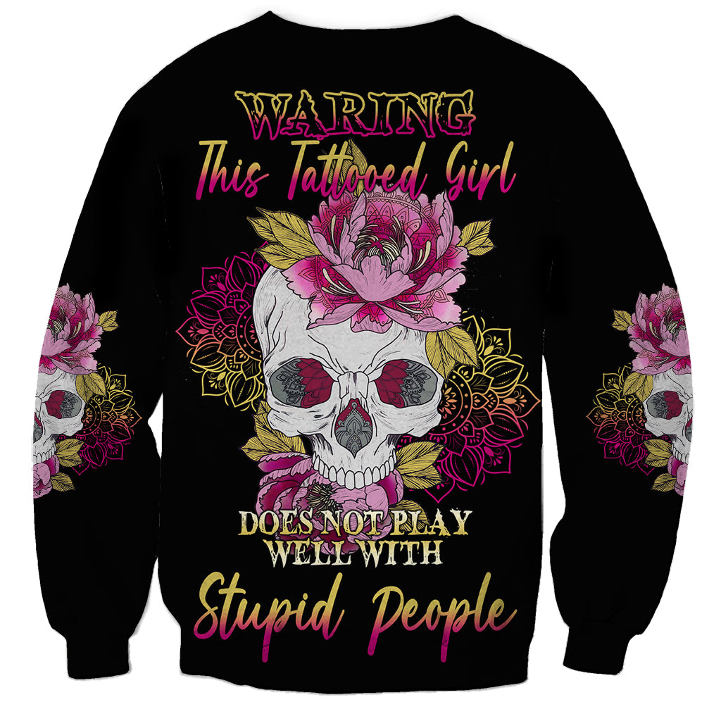Unisex black sweatshirt with multicolor skull-and-flowers graphic and full front text