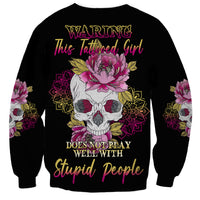Unisex black sweatshirt with multicolor skull-and-flowers graphic and full front text