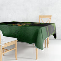 Green tablecloth with black check stripe design and rabbit graphic, draped on table