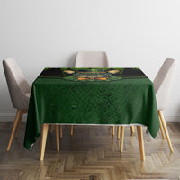 Square green tablecloth with black plaid bands and rabbit illustration on top