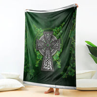 Green Irish cross and shamrock floral blanket hanging, showing full cross motif