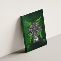 Green canvas wall art hanging on wall with Celtic Irish cross and shamrock vine