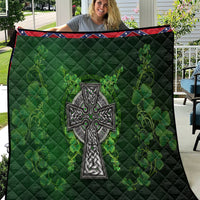 Dark green quilt with stitched diamond pattern and large Celtic cross with shamrock floral print