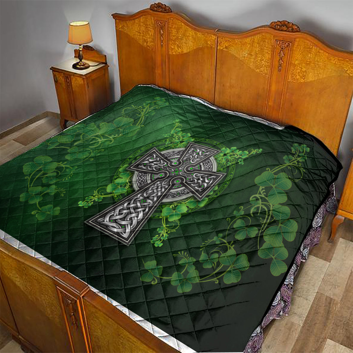 Dark green quilt on bed with Celtic cross emblem and shamrock floral vines in green