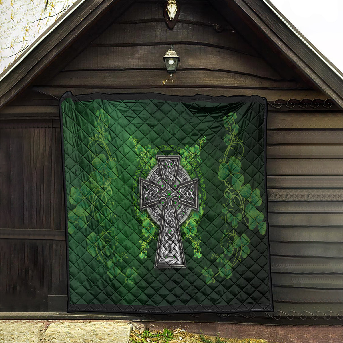 Dark green outdoor quilt with Celtic cross centerpiece and shamrock floral clover print