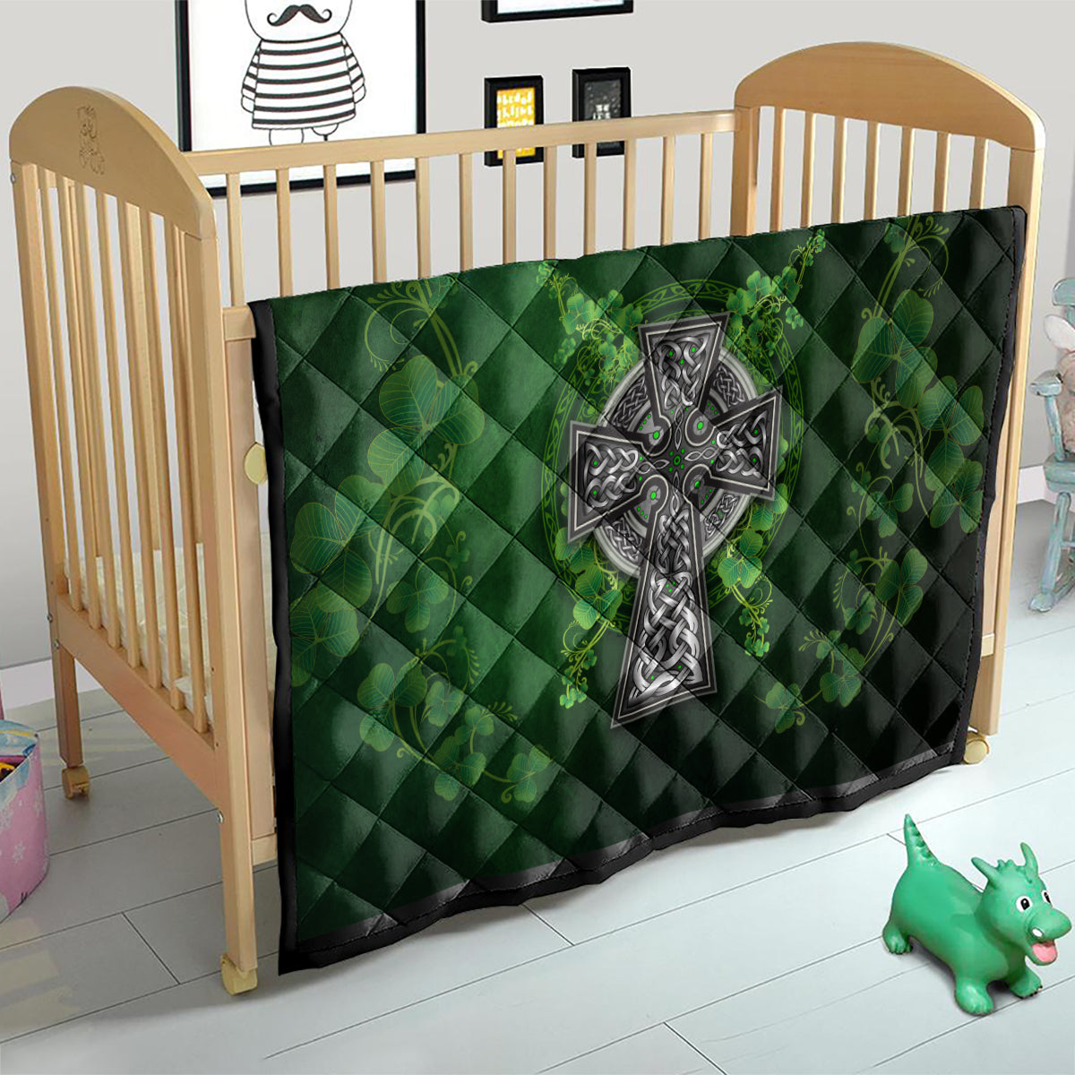 Dark green quilt on crib with Celtic cross motif and shamrock floral vine print