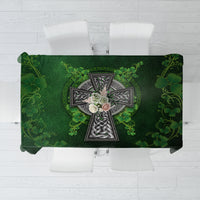 Rectangular green tablecloth with Irish cross and shamrock floral print, top view.