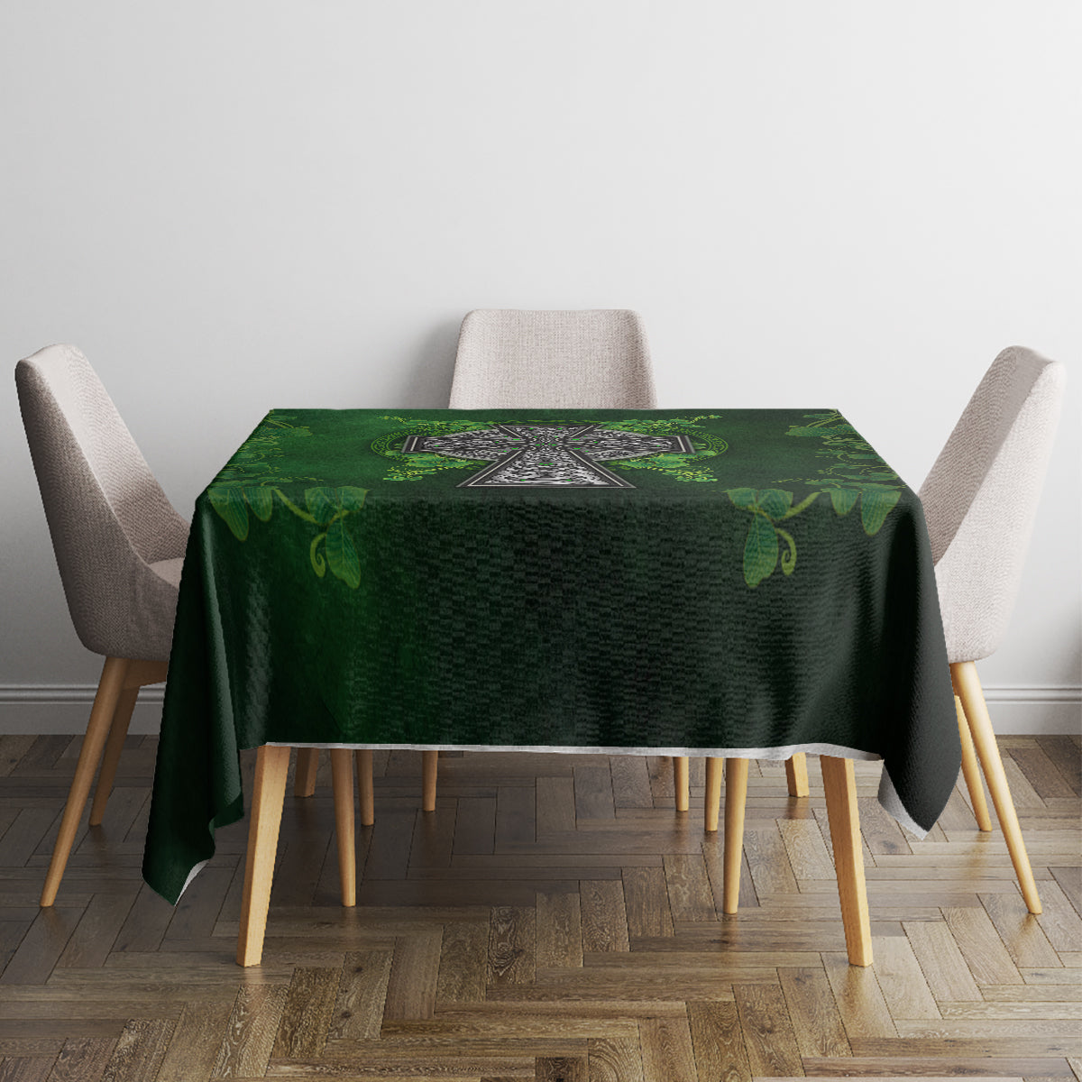 Green rectangular tablecloth with Irish cross and leaf pattern, laid on dining table.