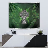 Decorative green tapestry with shamrock floral pattern and central Celtic cross in dark and silver tones