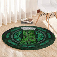 Round green rug with Celtic circle medallion pattern, near white chair