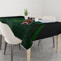 Green tablecloth with Celtic circle and beer cup motifs, draped over table edges