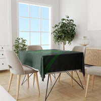 Green patterned tablecloth with Celtic circle and beer cup design on dining table