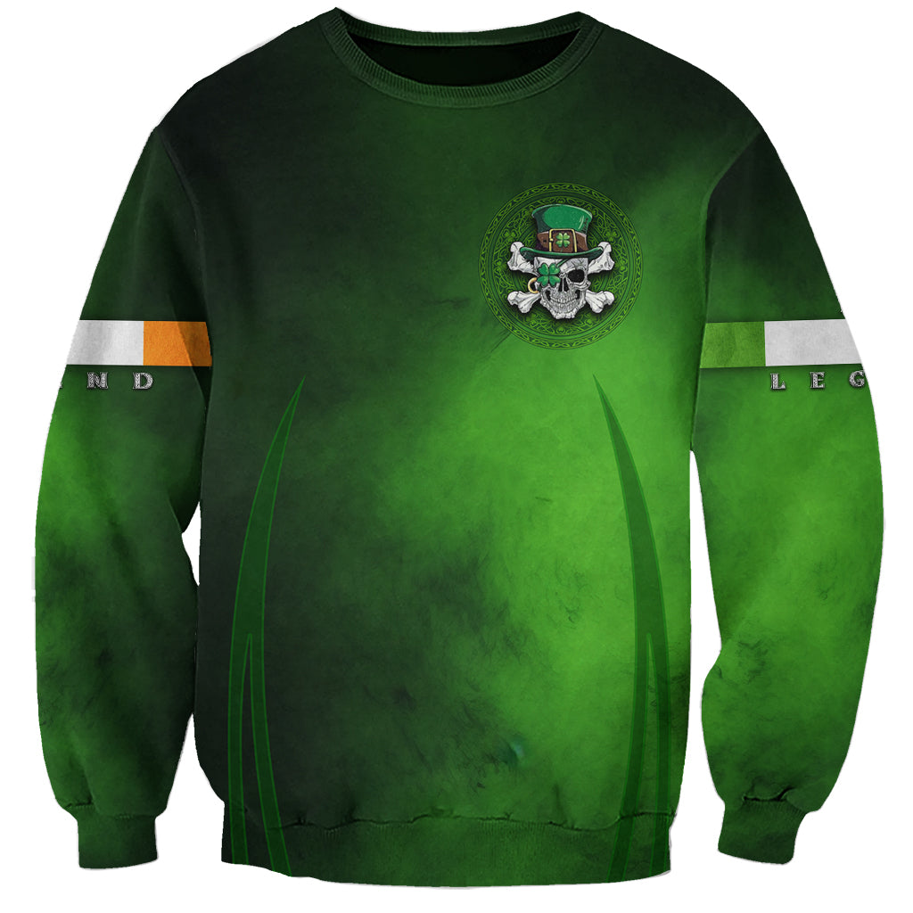 Green crewneck sweatshirt with small crest and skull emblem graphic on the front