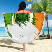 Round fringe beach blanket held up, multicolor clover and green leprechaun graphic