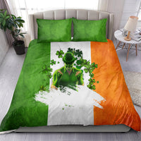 Bedding set showing leprechaun and shamrocks in green, white stripe, and orange