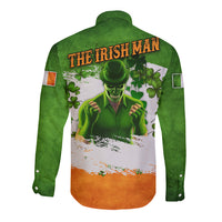 Green long-sleeve button shirt with shamrock and skull back graphic, orange hem stripe