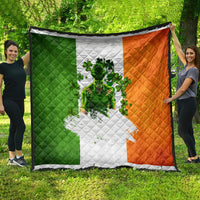 Irish-themed quilt hanging outdoors, green white and orange panels with clover figure