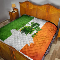 Irish-themed quilt on bed, green and orange diagonal panels with white clover figure