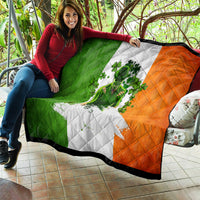 Irish-themed quilt draped on couch, green and orange panels with clover figure artwork