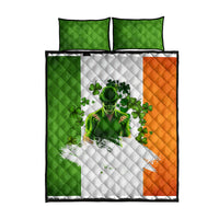 Quilt bed set flatlay with two green shams and a white quilt panel with green shamrocks and orange side