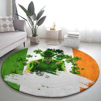 Round carpet with green clovers, skull portrait, and orange-green split border on gray