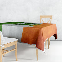 Multicolor tablecloth with green, orange, and white shamrock graphic; corner drape.
