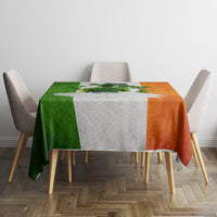 Multicolor tablecloth with green, white, and orange blocks and shamrock print.