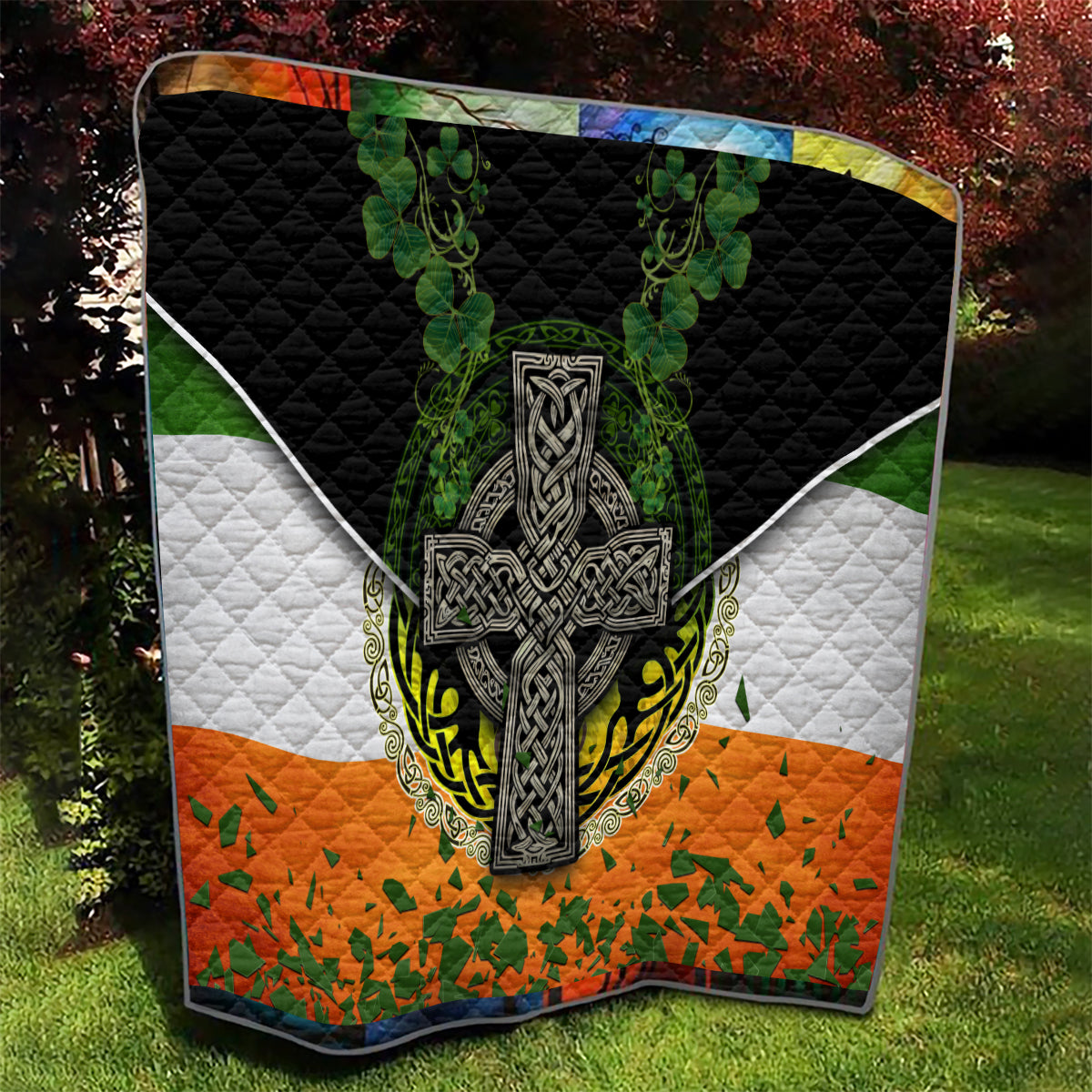 Quilt with Irish cross emblem, black border, white diamonds, green clover and orange patchwork