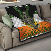 Irish cross quilt on sofa with black top, white diamond stripes, green shamrock and orange bottom
