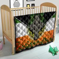 Irish cross quilt in crib with black border, green shamrock center, white diamonds and orange panel