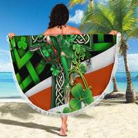 Round beach blanket with green Irish cross clover artwork and white fringed trim.