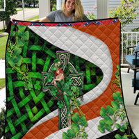 Multicolor Irish-themed quilt with large white cross, green clovers, and orange border