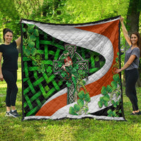 Multicolor shamrock quilt featuring a central white cross, green vines, and orange side panels
