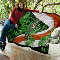 Quilt with white cross design, green clovers and vines, and orange corner sections