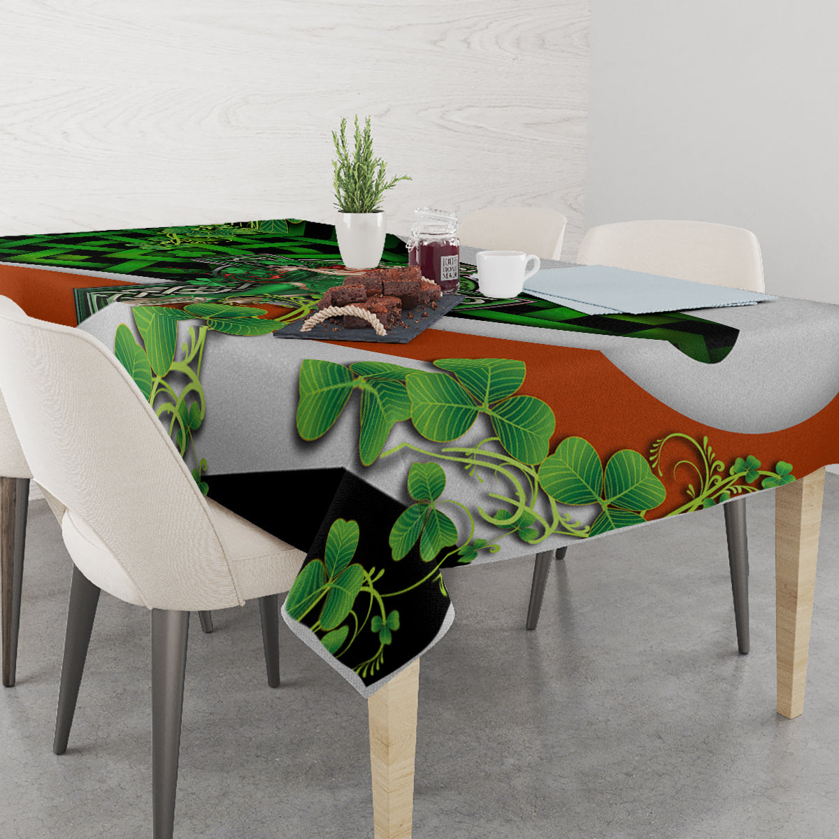 Decorative tablecloth featuring green clover leaves, orange panel, and Celtic accents