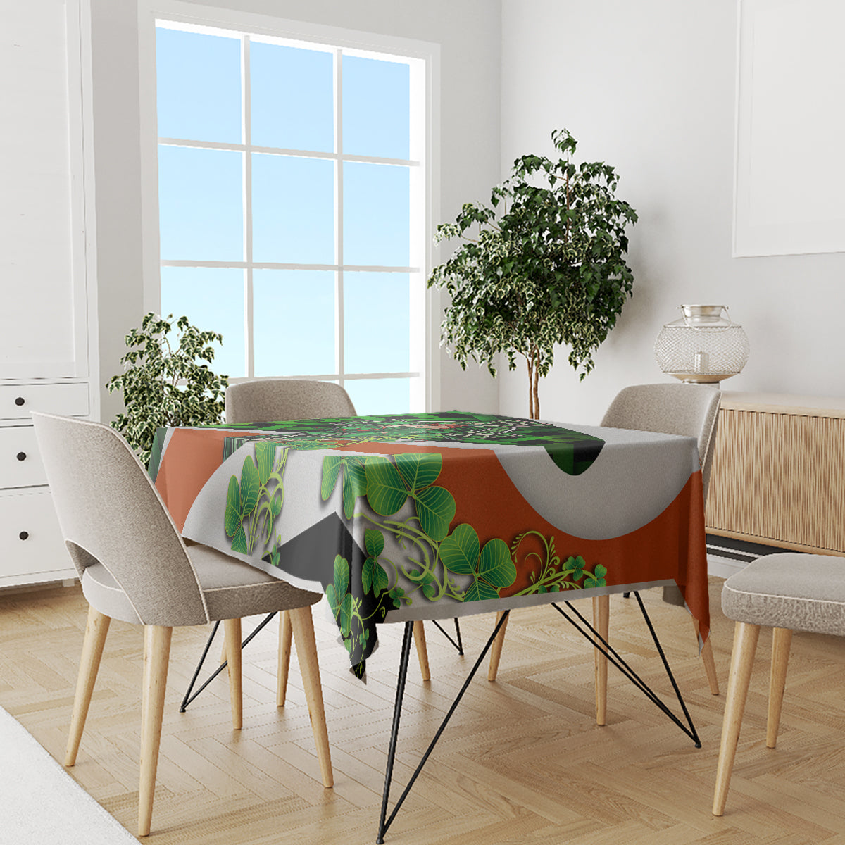 Green, orange, and gray decorative tablecloth with shamrocks and Celtic knot motifs