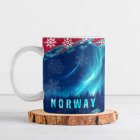 Blue ceramic mug with NORWAY text, northern lights, snowflakes, and red accents