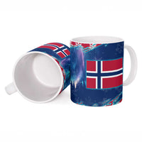 Red and blue ceramic mug with Norwegian flag graphic, snowflakes, and white handle