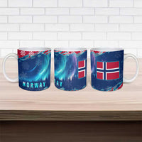 Three blue ceramic mugs with NORWAY design, flags, northern lights, and snowflakes