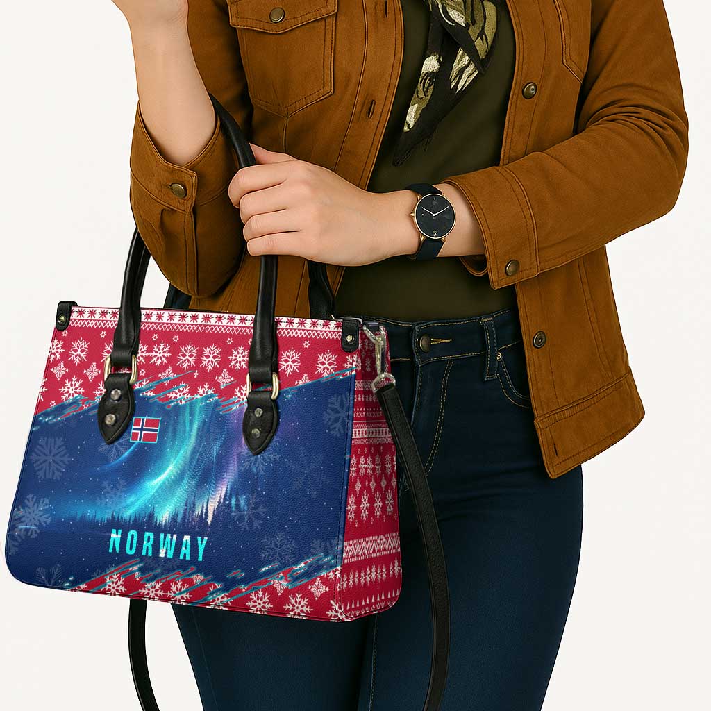 Red and blue winter tote bag with Norway text, held with crossbody strap