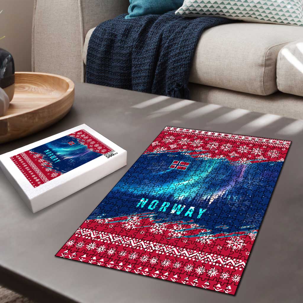 Flat lay of red and blue Norway jigsaw puzzle with Northern Lights snowflake border