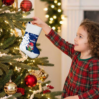 Blue and white Christmas stocking with Santa gnome design hanging from a tree