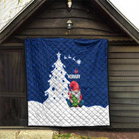 Blue and white quilt displayed indoors with Norway text, gnome Santa, and Christmas tree