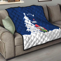 Blue and white quilt on sofa with Norway text, gnome Santa, and sweeping Christmas tree