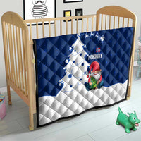 Blue and white quilt in a nursery on a toddler bed with Norway gnome Santa and tree