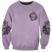 Purple unisex sweatshirt with small skull-and-flower emblem and rose prints on sleeves