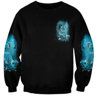 Black unisex crewneck sweatshirt with small blue mermaid graphic on chest
