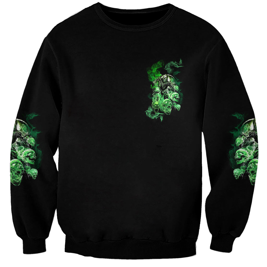 Black unisex skull graphic sweatshirt with small chest print and green sleeve smoke