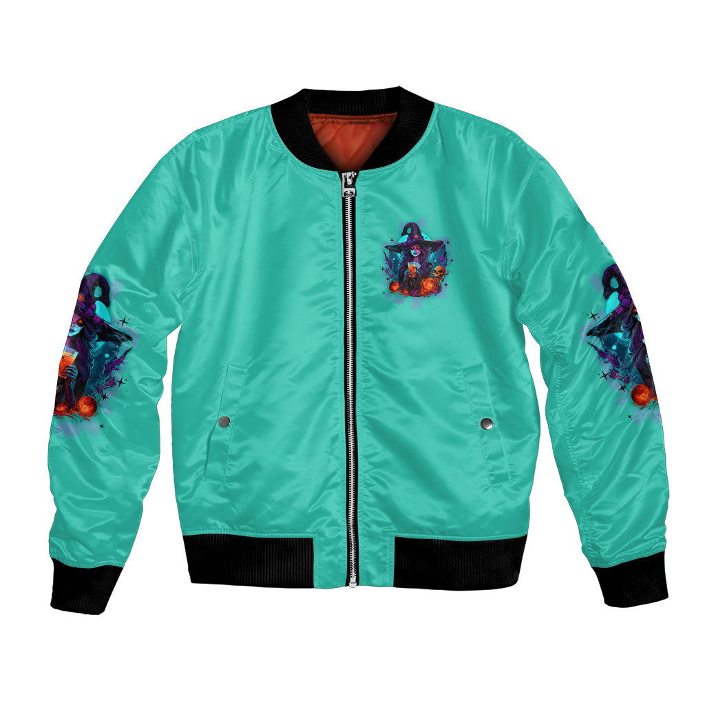 Turquoise zip-up bomber jacket with chest patch, black ribbed cuffs, and sleeve witch art